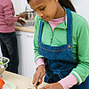 Fontbonne University > Girl working in kitchen with her mother